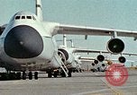 Image of  F-5E Tiger II fighters being loaded on C-5 transport aircraft California United States USA, 1976, second 1 stock footage video 65675021081