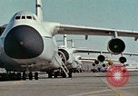 Image of  F-5E Tiger II fighters being loaded on C-5 transport aircraft California United States USA, 1976, second 3 stock footage video 65675021081
