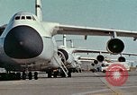Image of  F-5E Tiger II fighters being loaded on C-5 transport aircraft California United States USA, 1976, second 4 stock footage video 65675021081