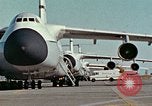 Image of  F-5E Tiger II fighters being loaded on C-5 transport aircraft California United States USA, 1976, second 5 stock footage video 65675021081