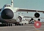 Image of  F-5E Tiger II fighters being loaded on C-5 transport aircraft California United States USA, 1976, second 6 stock footage video 65675021081