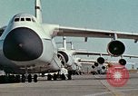 Image of  F-5E Tiger II fighters being loaded on C-5 transport aircraft California United States USA, 1976, second 7 stock footage video 65675021081