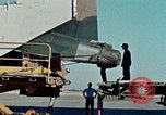 Image of  F-5E Tiger II fighters being loaded on C-5 transport aircraft California United States USA, 1976, second 14 stock footage video 65675021081