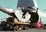 Image of  F-5E Tiger II fighters being loaded on C-5 transport aircraft California United States USA, 1976, second 16 stock footage video 65675021081