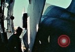 Image of  F-5E Tiger II fighters being loaded on C-5 transport aircraft California United States USA, 1976, second 20 stock footage video 65675021081