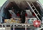 Image of  F-5E Tiger II fighters being loaded on C-5 transport aircraft California United States USA, 1976, second 30 stock footage video 65675021081