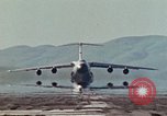 Image of  F-5E Tiger II fighters being loaded on C-5 transport aircraft California United States USA, 1976, second 31 stock footage video 65675021081