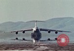 Image of  F-5E Tiger II fighters being loaded on C-5 transport aircraft California United States USA, 1976, second 32 stock footage video 65675021081