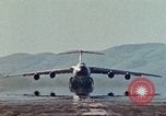 Image of  F-5E Tiger II fighters being loaded on C-5 transport aircraft California United States USA, 1976, second 33 stock footage video 65675021081