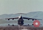 Image of  F-5E Tiger II fighters being loaded on C-5 transport aircraft California United States USA, 1976, second 34 stock footage video 65675021081
