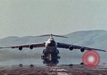 Image of  F-5E Tiger II fighters being loaded on C-5 transport aircraft California United States USA, 1976, second 35 stock footage video 65675021081