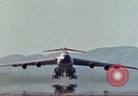 Image of  F-5E Tiger II fighters being loaded on C-5 transport aircraft California United States USA, 1976, second 36 stock footage video 65675021081
