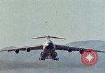 Image of  F-5E Tiger II fighters being loaded on C-5 transport aircraft California United States USA, 1976, second 37 stock footage video 65675021081