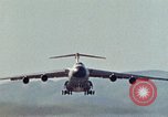 Image of  F-5E Tiger II fighters being loaded on C-5 transport aircraft California United States USA, 1976, second 38 stock footage video 65675021081