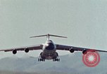Image of  F-5E Tiger II fighters being loaded on C-5 transport aircraft California United States USA, 1976, second 39 stock footage video 65675021081