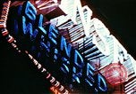 Image of Times Square neon lights in rain New York City USA, 1954, second 28 stock footage video 65675021110