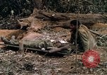 Image of wounded rescued by Huey helicopter South Vietnam, 1967, second 49 stock footage video 65675021192