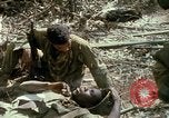 Image of wounded rescued by Huey helicopter South Vietnam, 1967, second 56 stock footage video 65675021192