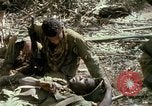 Image of wounded rescued by Huey helicopter South Vietnam, 1967, second 61 stock footage video 65675021192