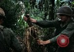 Immagine di I soldati degli Stati Uniti di smantellare e masterizzare il supporto NVA capanne in villaggio Il Vietnam, 1968, secondo 27 filmato di repertorio 65675021203
