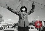 Image of Traffic policeman under umbrella Baghdad Iraq, 1942, second 9 stock footage video 65675022192