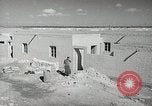 Image of Traffic policeman under umbrella Baghdad Iraq, 1942, second 19 stock footage video 65675022192