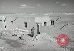 Image of Traffic policeman under umbrella Baghdad Iraq, 1942, second 21 stock footage video 65675022192