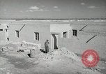 Image of Traffic policeman under umbrella Baghdad Iraq, 1942, second 22 stock footage video 65675022192