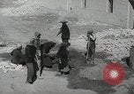 Image of Traffic policeman under umbrella Baghdad Iraq, 1942, second 28 stock footage video 65675022192