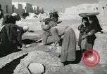 Image of Traffic policeman under umbrella Baghdad Iraq, 1942, second 30 stock footage video 65675022192