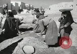 Image of Traffic policeman under umbrella Baghdad Iraq, 1942, second 33 stock footage video 65675022192