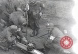 Image of Medics tend to wounded U.S. soldiers on beach Normandy France, 1944, second 1 stock footage video 65675022977