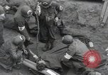 Image of Medics tend to wounded U.S. soldiers on beach Normandy France, 1944, second 3 stock footage video 65675022977