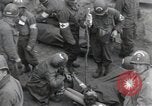 Image of Medics tend to wounded U.S. soldiers on beach Normandy France, 1944, second 4 stock footage video 65675022977