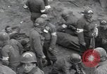 Image of Medics tend to wounded U.S. soldiers on beach Normandy France, 1944, second 5 stock footage video 65675022977