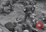 Image of Medics tend to wounded U.S. soldiers on beach Normandy France, 1944, second 6 stock footage video 65675022977