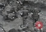 Image of Medics tend to wounded U.S. soldiers on beach Normandy France, 1944, second 7 stock footage video 65675022977