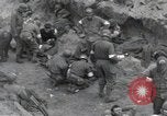 Image of Medics tend to wounded U.S. soldiers on beach Normandy France, 1944, second 8 stock footage video 65675022977