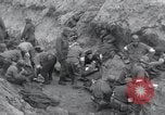 Image of Medics tend to wounded U.S. soldiers on beach Normandy France, 1944, second 10 stock footage video 65675022977