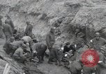 Image of Medics tend to wounded U.S. soldiers on beach Normandy France, 1944, second 11 stock footage video 65675022977