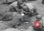 Image of Medics tend to wounded U.S. soldiers on beach Normandy France, 1944, second 13 stock footage video 65675022977