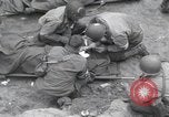 Image of Medics tend to wounded U.S. soldiers on beach Normandy France, 1944, second 14 stock footage video 65675022977