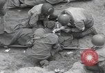 Image of Medics tend to wounded U.S. soldiers on beach Normandy France, 1944, second 15 stock footage video 65675022977