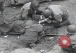 Image of Medics tend to wounded U.S. soldiers on beach Normandy France, 1944, second 16 stock footage video 65675022977