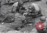 Image of Medics tend to wounded U.S. soldiers on beach Normandy France, 1944, second 17 stock footage video 65675022977