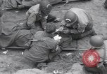 Image of Medics tend to wounded U.S. soldiers on beach Normandy France, 1944, second 18 stock footage video 65675022977