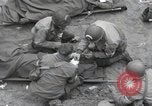 Image of Medics tend to wounded U.S. soldiers on beach Normandy France, 1944, second 19 stock footage video 65675022977