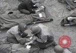 Image of Medics tend to wounded U.S. soldiers on beach Normandy France, 1944, second 20 stock footage video 65675022977