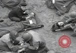 Image of Medics tend to wounded U.S. soldiers on beach Normandy France, 1944, second 21 stock footage video 65675022977