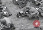Image of Medics tend to wounded U.S. soldiers on beach Normandy France, 1944, second 22 stock footage video 65675022977